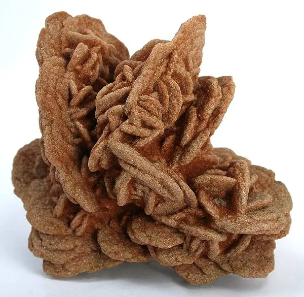 A cluster of reddish-brown, sandy, petal-shaped plates growing together like the petals of a rose