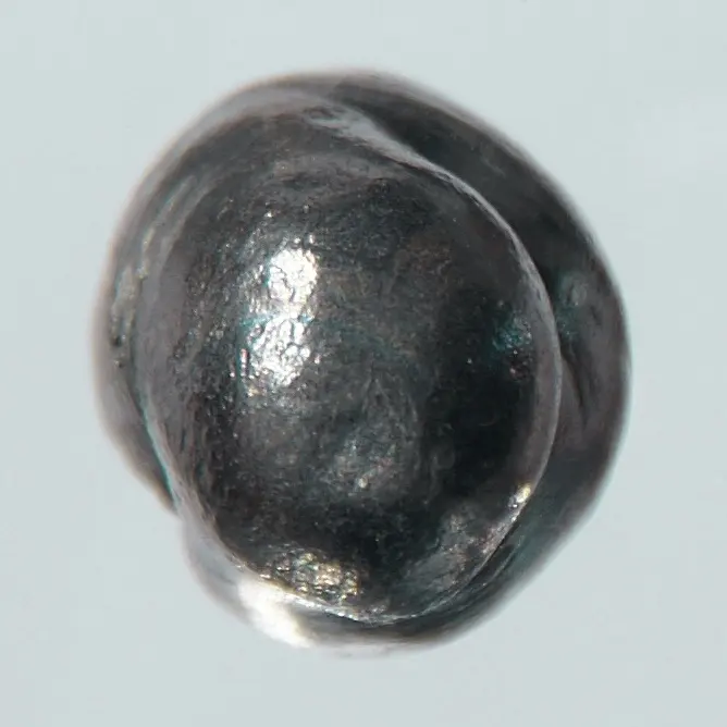 A rounded, dull gray lump of metal with a slightly shiny, lumpy surface