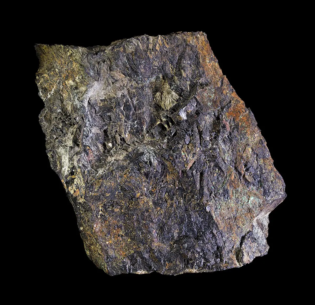 A dark brown, almost black, rough rock with rusty-orange and yellowish patches, on a black background