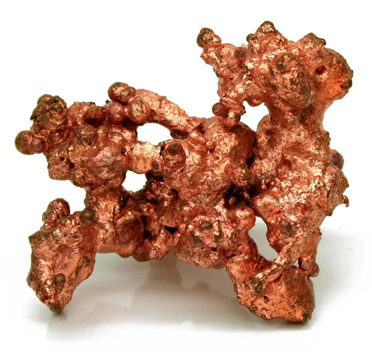 A twisted lump of shiny, salmon-pink metal on a white background