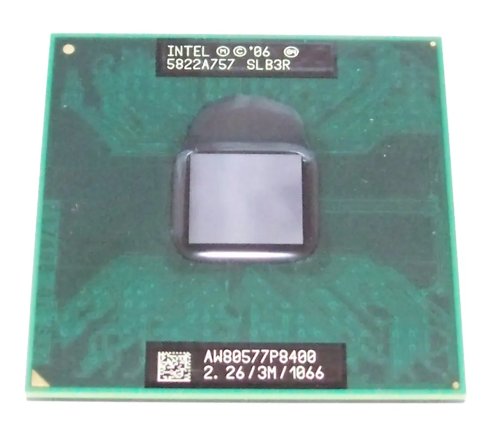 A square green circuit board, about the size of a stamp, with a shiny gray square in its middle and printed codes at the top and bottom