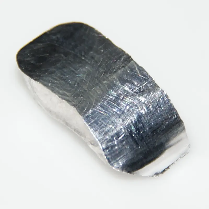 A bent, shiny, silvery strip of metal covered in fine scratches, on a white background