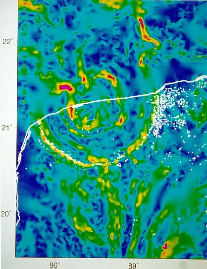 A colorful map in blues, greens, yellows and reds, crossed by a white coastline, with curved bands forming part of a large ring
