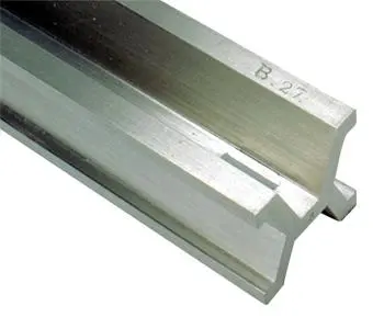 Close-up of the end of a shiny silvery metal bar, X-shaped where it is cut, stamped B. 27 on top