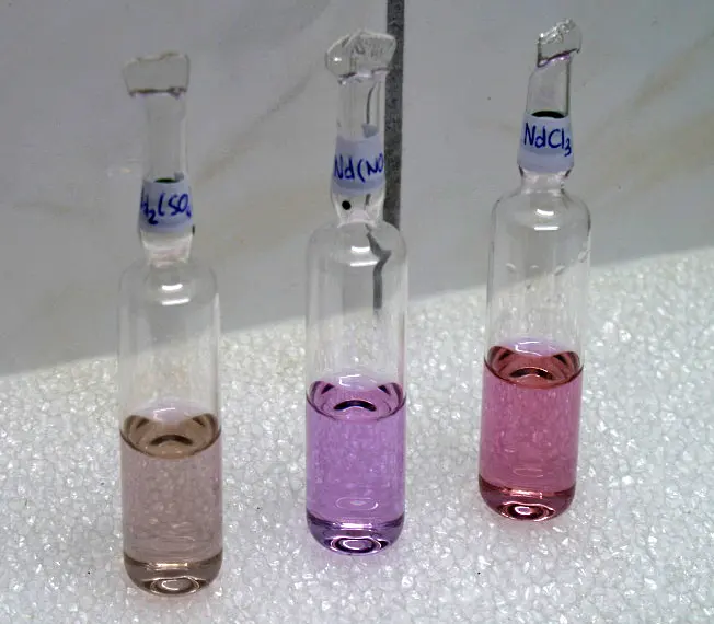 The same three ampoules: now the first liquid looks pale gray-brown, the second violet and the third pink