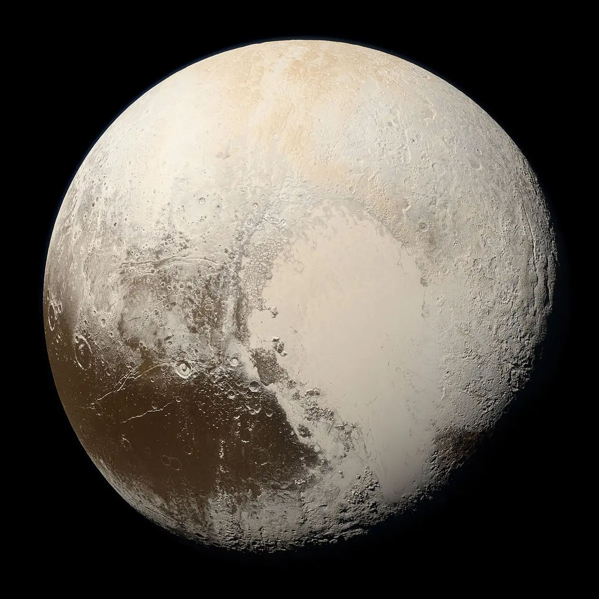A round, pale brown and cream world against black space, with a large bright heart-shaped plain