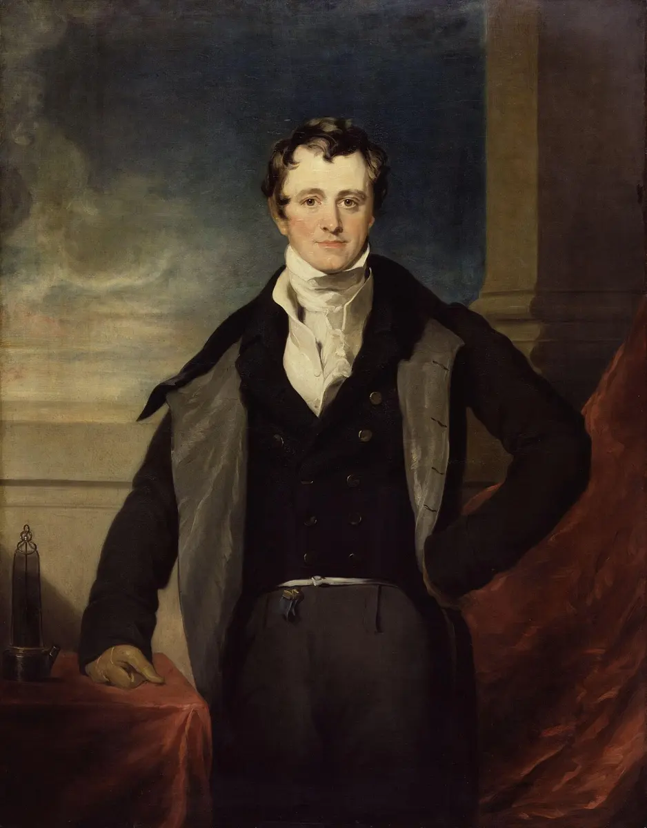 A painted portrait of a young man with dark curly hair, in a dark coat, white neckcloth and gray cloak, standing with one hand on a table covered in red cloth