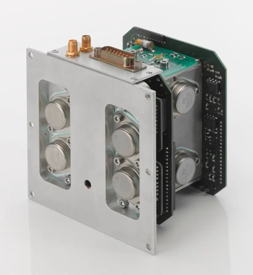 An aluminium frame holding several round silver parts behind two windows, with green circuit boards and connectors at the back and top