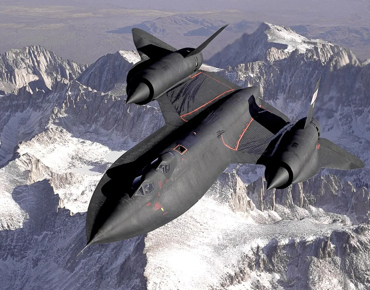 A long, flat, black jet aircraft with two large engines in its wings, flying above snow-covered mountains