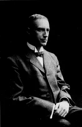An old black-and-white portrait photograph of a seated man in a dark suit