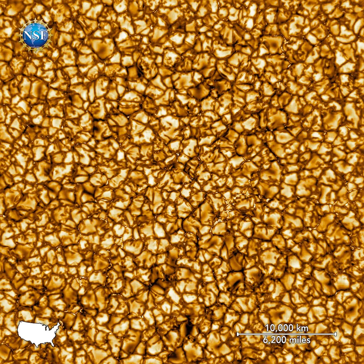 A close-up of the Sun's surface: a pattern of bright, rounded cells like grains of rice, separated by thin dark lanes, with a scale bar