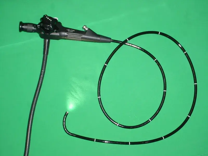 A flexible endoscope: a long black tube coiled up, with a control handle