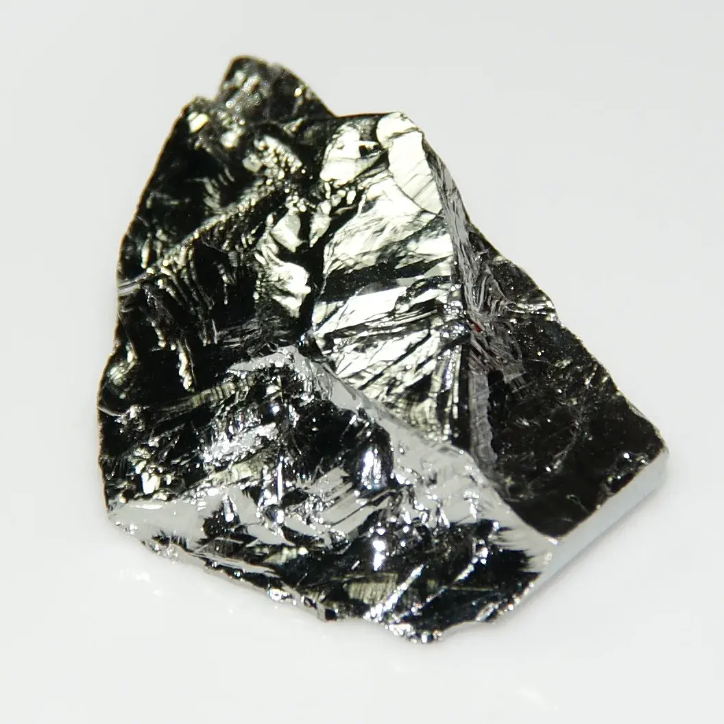 A shiny, gray, broken lump of germanium