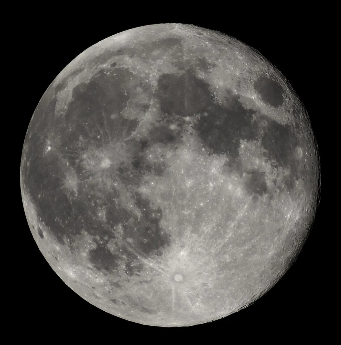 The full Moon: a bright gray disc with darker gray patches and many small craters