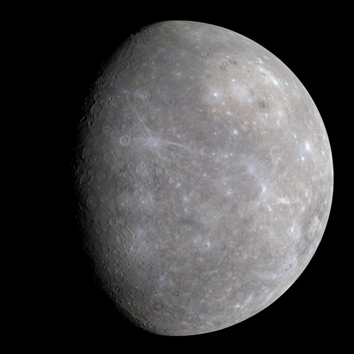 A gray, cratered planet against black space, with faint patches of tan and blue