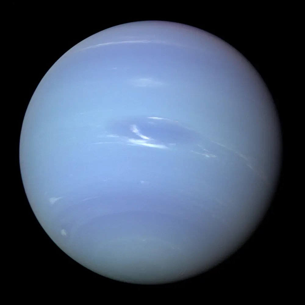 A deep blue planet with a dark oval spot and a few white streaks of cloud