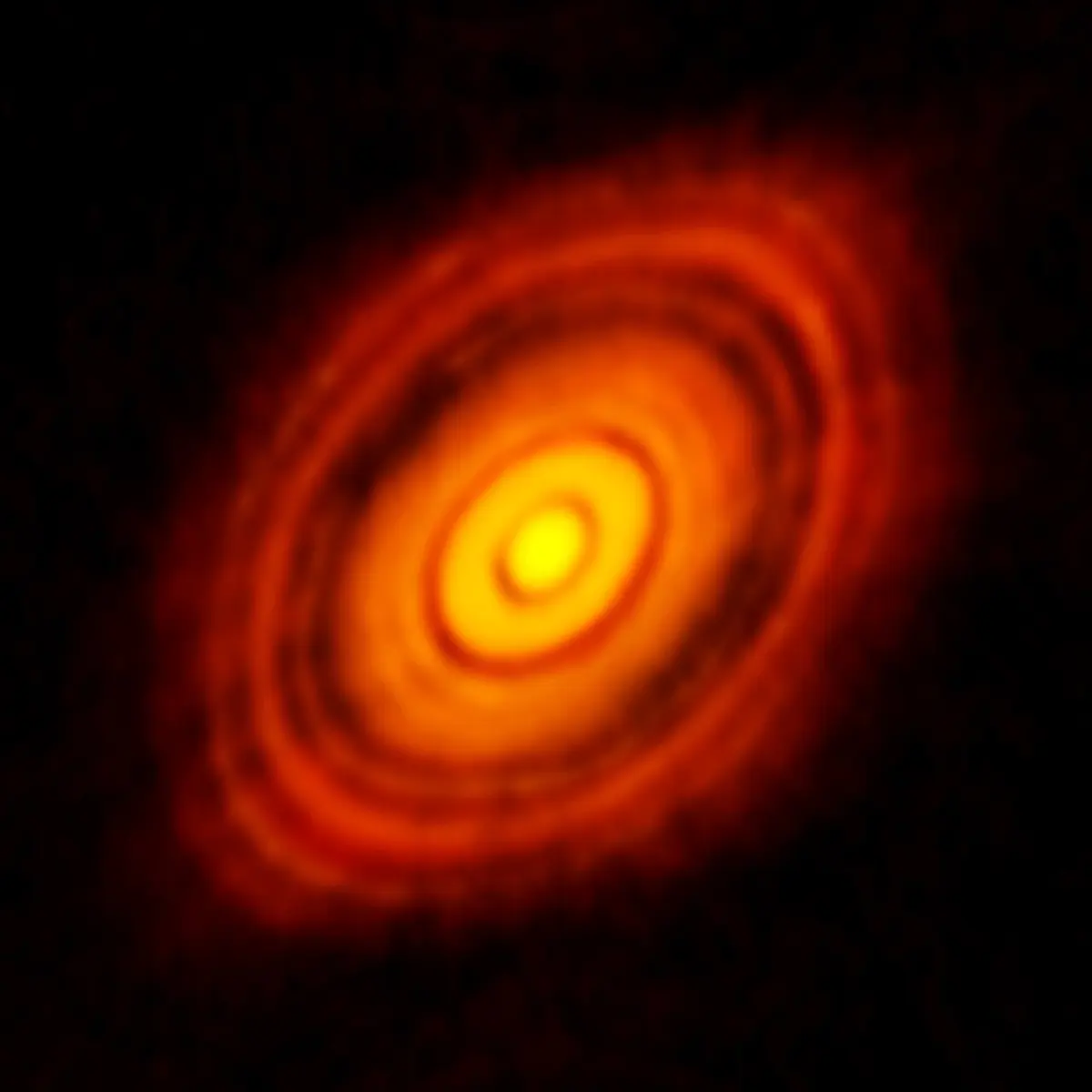 A glowing orange disc seen at a slant, with dark rings and gaps in it, around a bright center