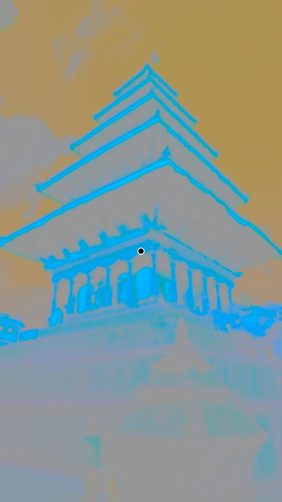 A photo of the Nyatapola temple in Bhaktapur in strange colors: an orange sky and blue-green temples, with a black dot in the middle