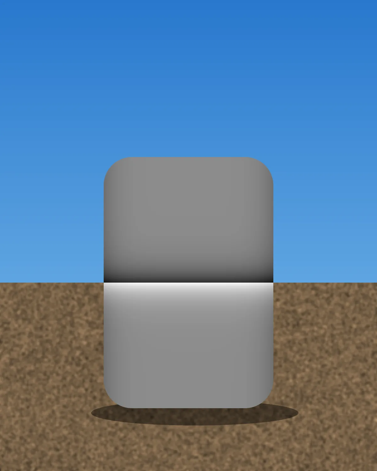 A rounded block on brown ground under a blue sky, its top half dark gray and its bottom half white