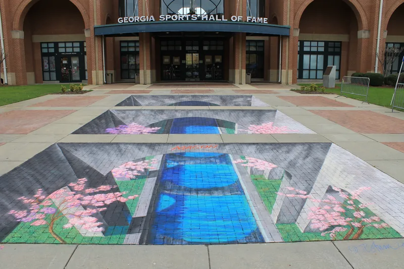 A chalk drawing on the ground that looks like a deep pool cut into the pavement