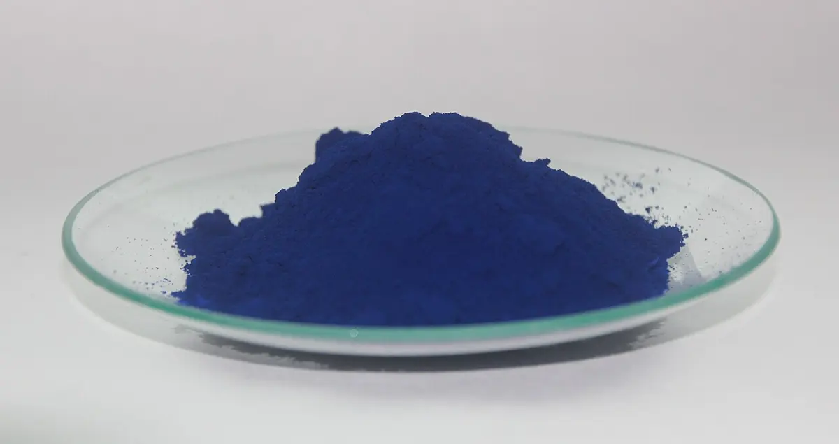 A heap of fine, deep blue powder in a shallow glass dish