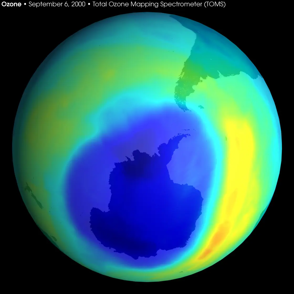 A globe seen from below the South Pole, colored green and yellow, with a large dark blue patch covering Antarctica and beyond