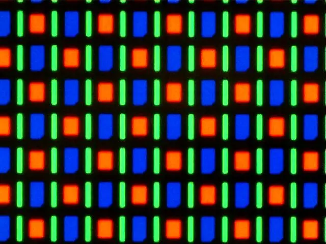 A close-up through a microscope of a phone screen: neat rows of tiny glowing red and blue squares and thin green bars on black