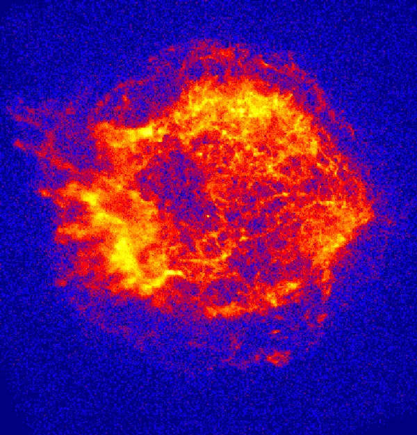 A round, ragged cloud of glowing red, orange and yellow wisps on a dark blue speckled background