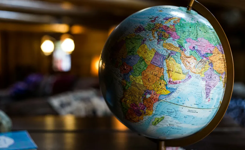 A colorful globe of the world on a table