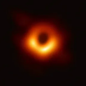 The first image of a black hole: a glowing orange ring around a dark center
