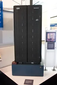 A tall black computer cabinet like Deep Blue, in a museum
