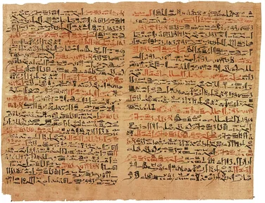 Two columns of ancient Egyptian writing in black and red ink on yellowed papyrus