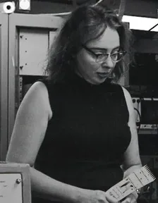 Marie Tharp aboard a research ship in 1968, studying a long paper record of the ocean’s depth