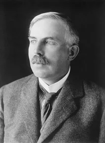 A photograph of Ernest Rutherford with a mustache