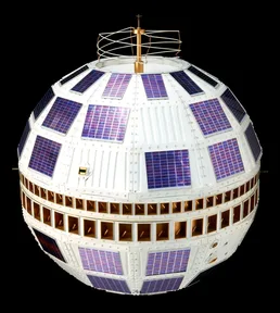 A copy of the Telstar 1 satellite: a ball covered in small solar panels